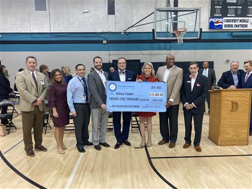 Board members and Madison Schools Superintendent Dr. Ed Nichols holding check with Kelsey Cooper